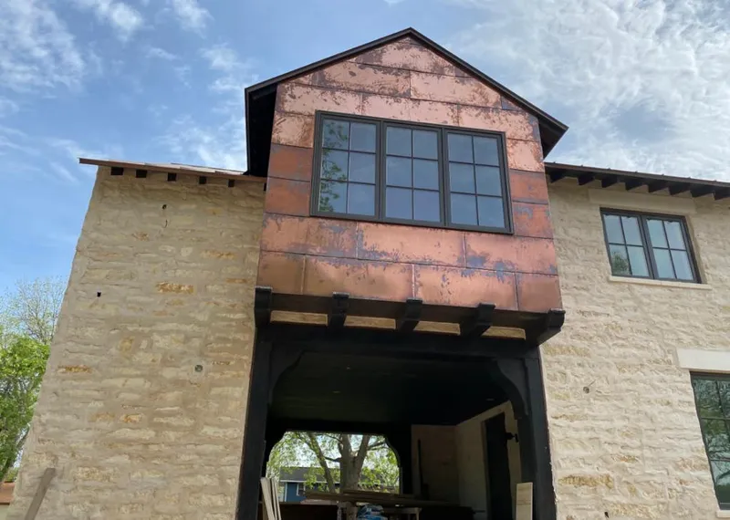 Copper metal panel facade on a stone building for Metal Roof Coating in Bethel
