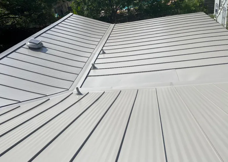 Solar attic fan installed on a metal roof for Roof Ventilation in Bethel
